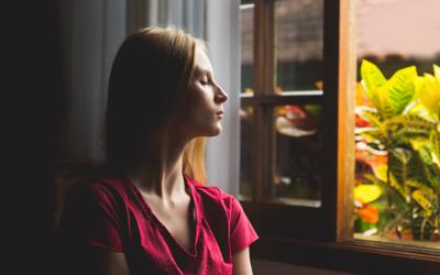 Girl meditating near window